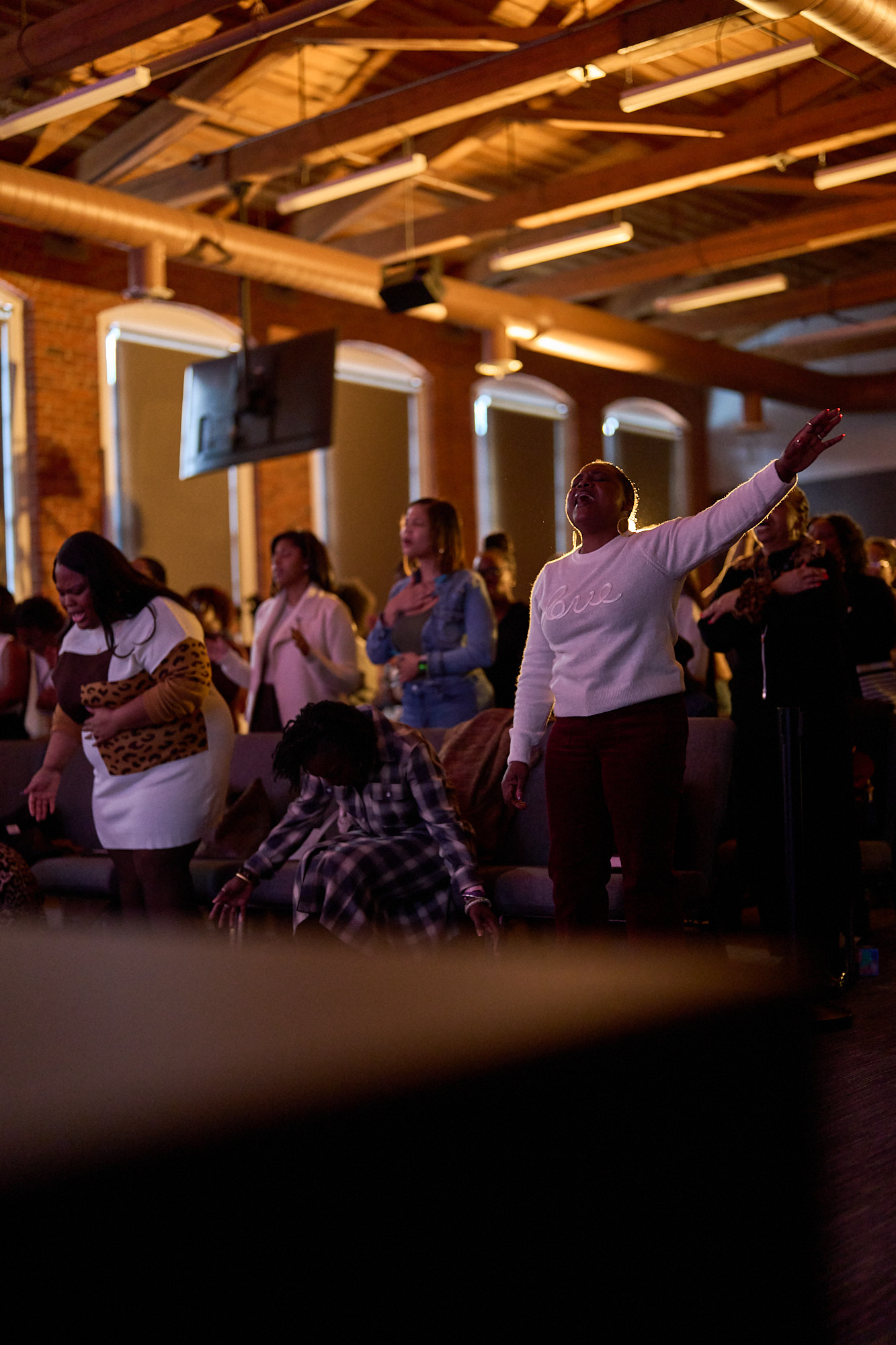 Worshippers with hands raised during a Sunday service at Heart of Worship Church